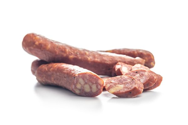 Sliced smoked ​​sausage isolated on a white background.